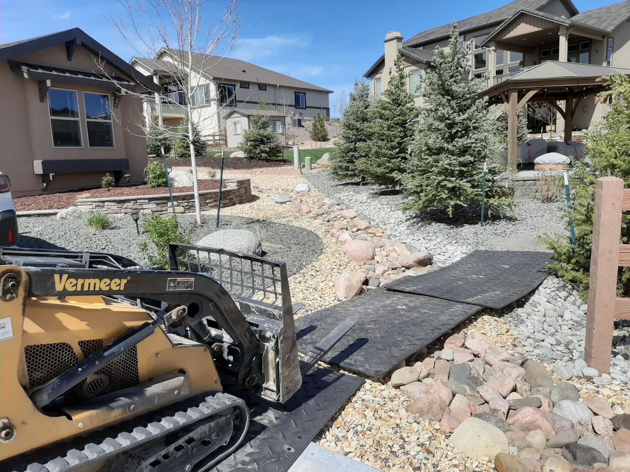 Skid steer and protective mats along the route to a planting site